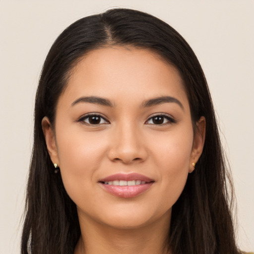 Joyful latino young-adult female with long  brown hair and brown eyes