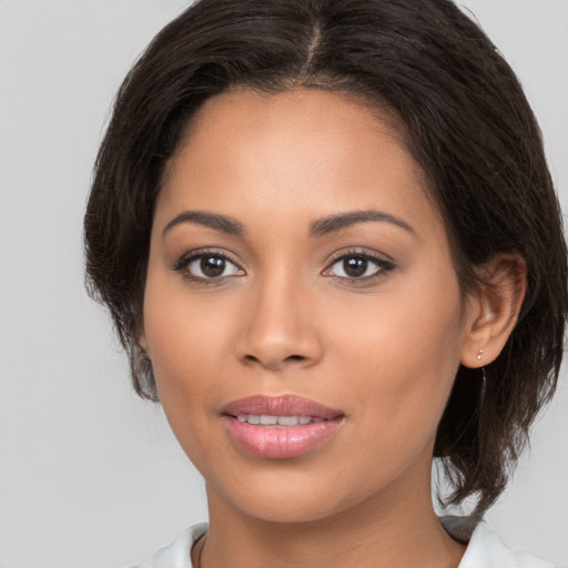 Joyful white young-adult female with medium  brown hair and brown eyes