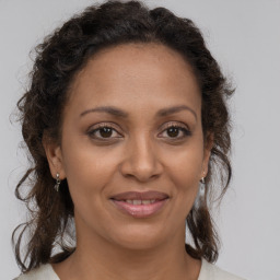 Joyful white adult female with medium  brown hair and brown eyes