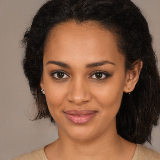 Joyful black young-adult female with medium  brown hair and brown eyes