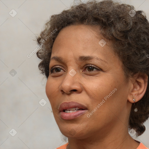 Joyful black adult female with short  brown hair and brown eyes