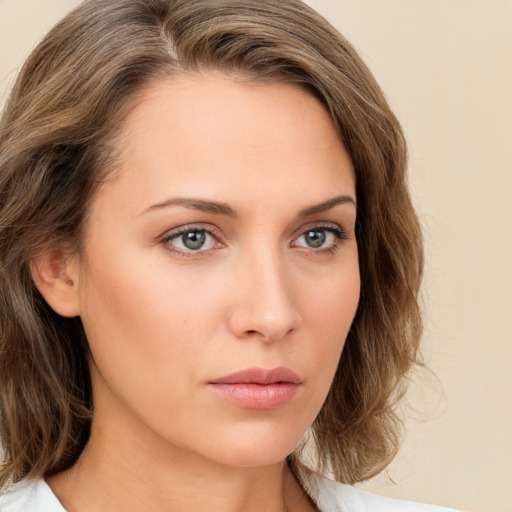 Neutral white young-adult female with long  brown hair and green eyes