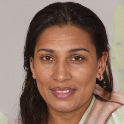 Joyful white adult female with medium  brown hair and brown eyes