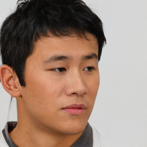 Neutral asian young-adult male with short  brown hair and brown eyes