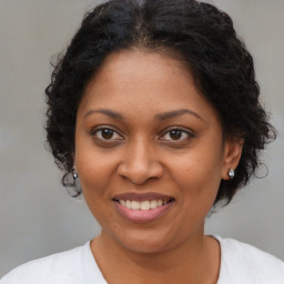 Joyful black young-adult female with medium  brown hair and brown eyes