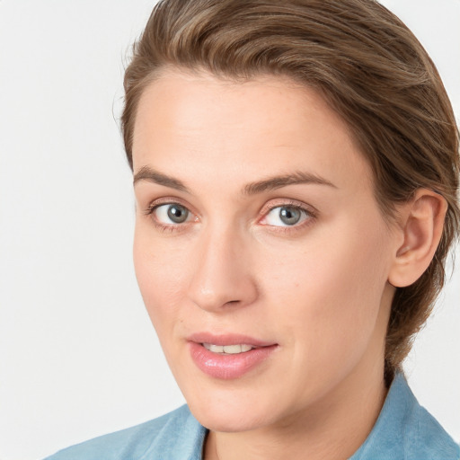 Joyful white young-adult female with medium  brown hair and blue eyes