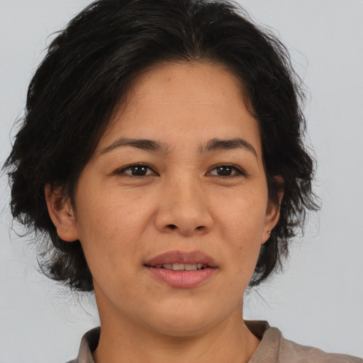 Joyful asian adult female with medium  brown hair and brown eyes