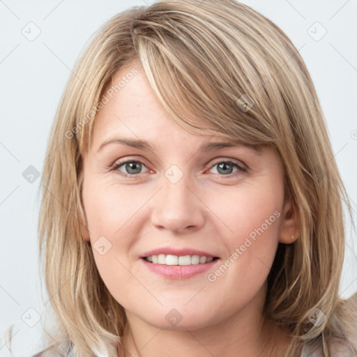 Joyful white young-adult female with medium  brown hair and blue eyes