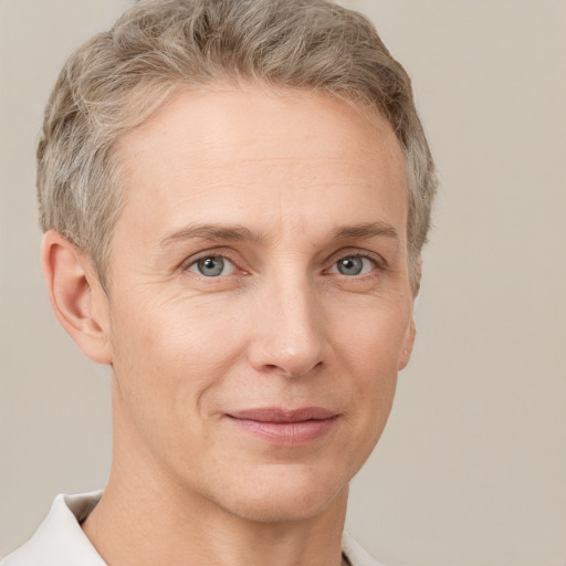 Joyful white adult female with short  brown hair and grey eyes