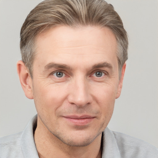 Joyful white adult male with short  brown hair and grey eyes