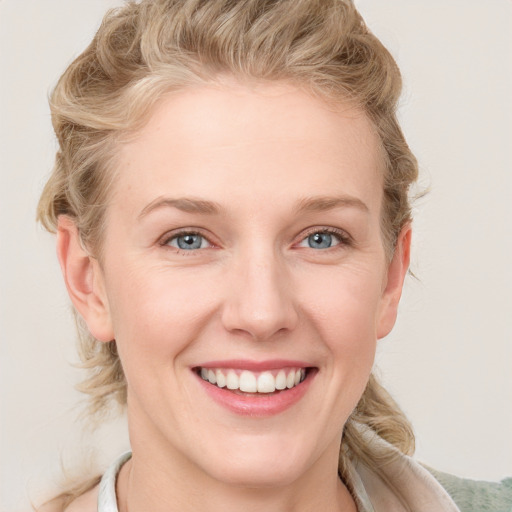 Joyful white young-adult female with medium  brown hair and blue eyes