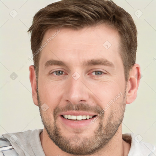 Joyful white young-adult male with short  brown hair and grey eyes