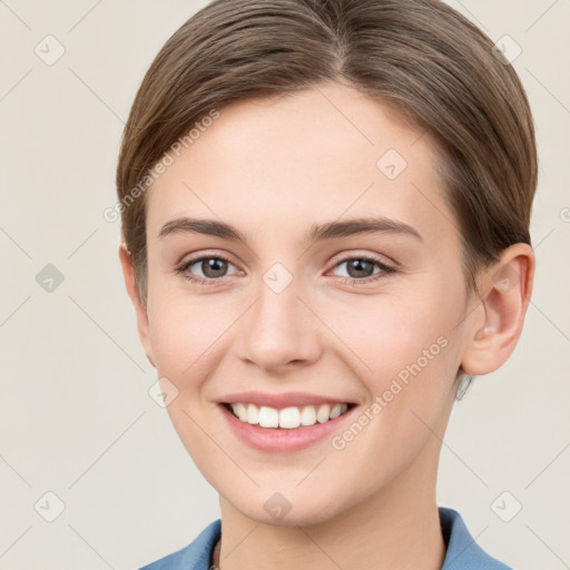 Joyful white young-adult female with short  brown hair and grey eyes