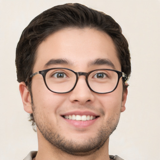 Joyful white young-adult male with short  brown hair and green eyes