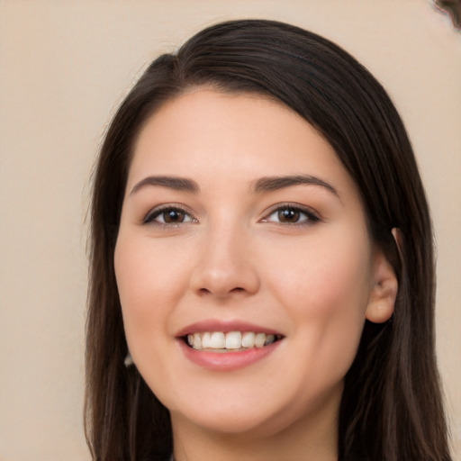 Joyful white young-adult female with long  brown hair and brown eyes