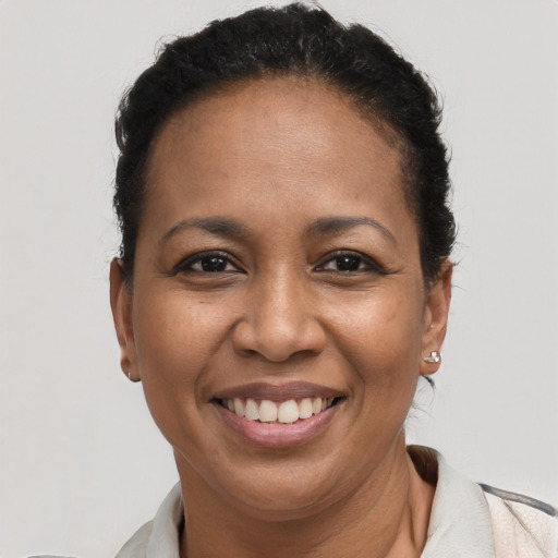 Joyful black adult female with short  brown hair and brown eyes