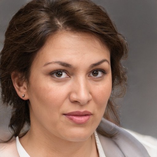 Joyful white adult female with medium  brown hair and brown eyes