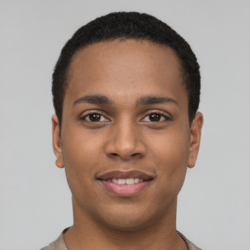 Joyful latino young-adult male with short  brown hair and brown eyes