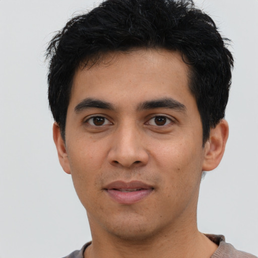 Joyful asian young-adult male with short  black hair and brown eyes