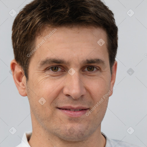 Joyful white adult male with short  brown hair and brown eyes