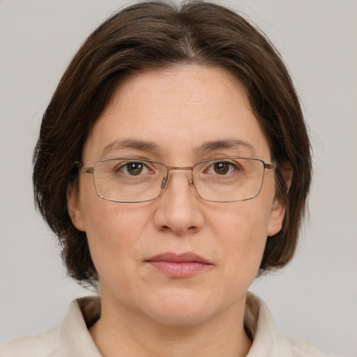 Joyful white adult female with medium  brown hair and grey eyes