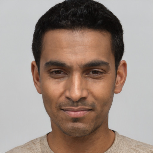 Joyful latino young-adult male with short  black hair and brown eyes