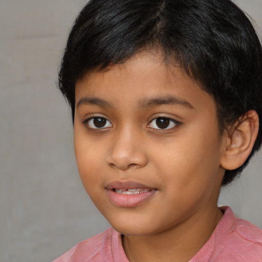 Joyful latino child female with short  brown hair and brown eyes