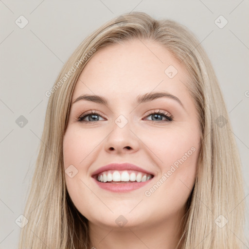 Joyful white young-adult female with long  brown hair and blue eyes