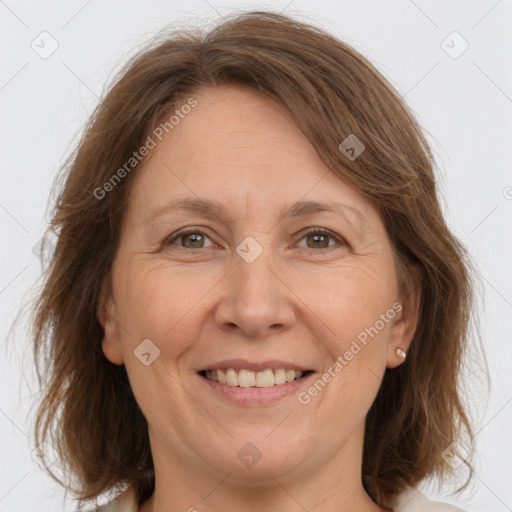 Joyful white adult female with medium  brown hair and grey eyes