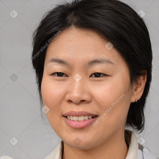 Joyful asian young-adult female with medium  brown hair and brown eyes