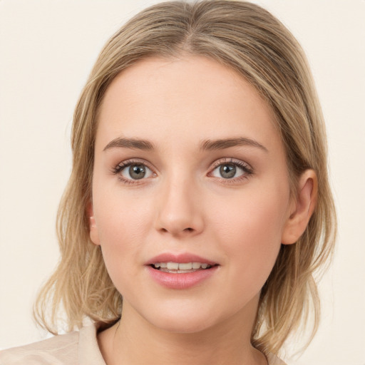 Joyful white young-adult female with medium  brown hair and green eyes