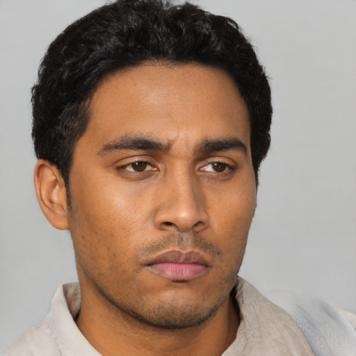 Neutral latino young-adult male with short  black hair and brown eyes