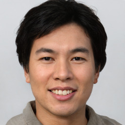 Joyful asian young-adult male with short  brown hair and brown eyes