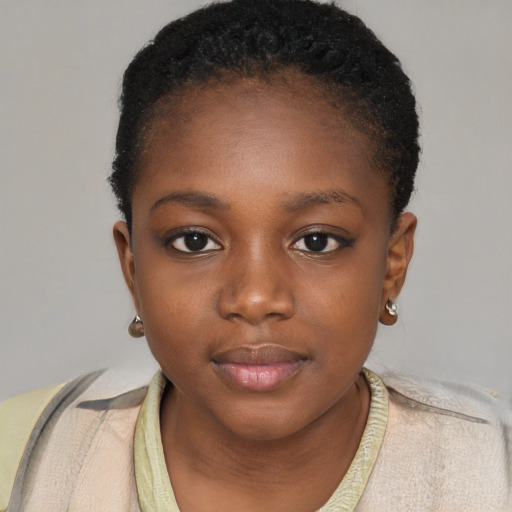 Joyful black child female with short  brown hair and brown eyes