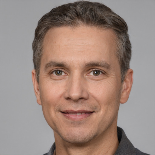 Joyful white adult male with short  brown hair and brown eyes