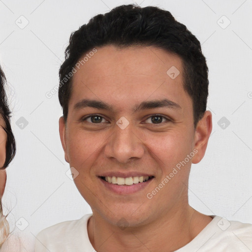 Joyful white young-adult male with short  black hair and brown eyes