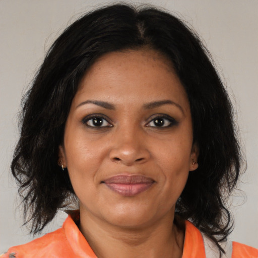 Joyful black young-adult female with medium  brown hair and brown eyes