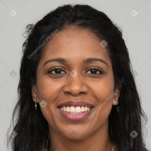 Joyful black young-adult female with long  brown hair and brown eyes