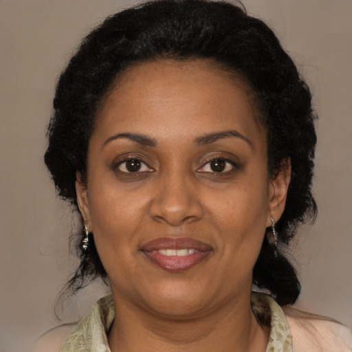 Joyful latino adult female with medium  brown hair and brown eyes