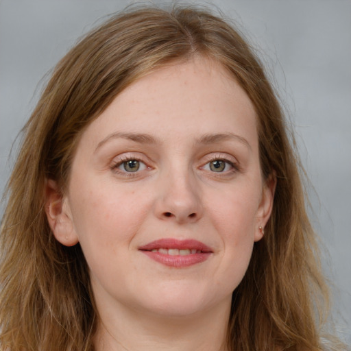 Joyful white young-adult female with long  brown hair and blue eyes