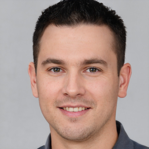 Joyful white young-adult male with short  brown hair and brown eyes