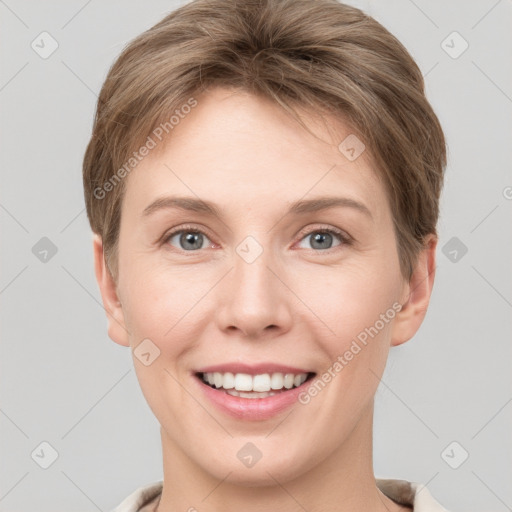 Joyful white young-adult female with short  brown hair and grey eyes