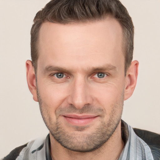 Joyful white adult male with short  brown hair and brown eyes