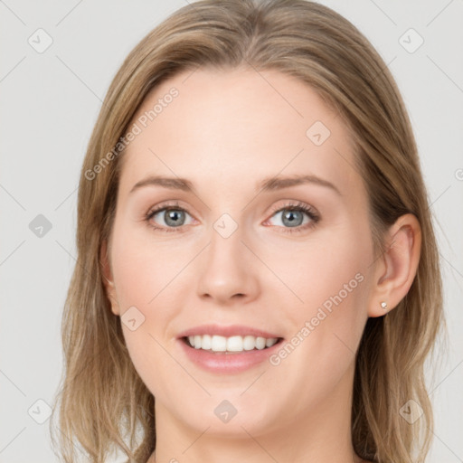 Joyful white young-adult female with long  brown hair and blue eyes