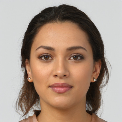 Joyful latino young-adult female with medium  brown hair and brown eyes