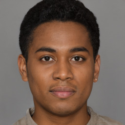 Joyful black young-adult male with short  brown hair and brown eyes