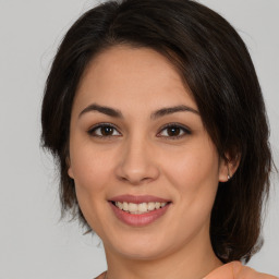 Joyful white young-adult female with medium  brown hair and brown eyes