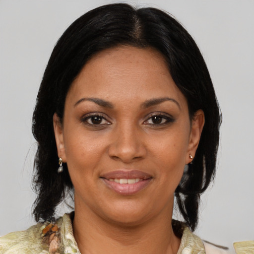 Joyful black young-adult female with medium  brown hair and brown eyes