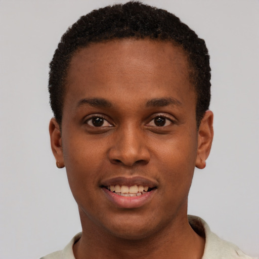 Joyful black young-adult male with short  brown hair and brown eyes