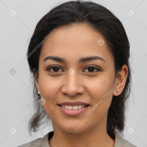 Joyful latino young-adult female with medium  brown hair and brown eyes